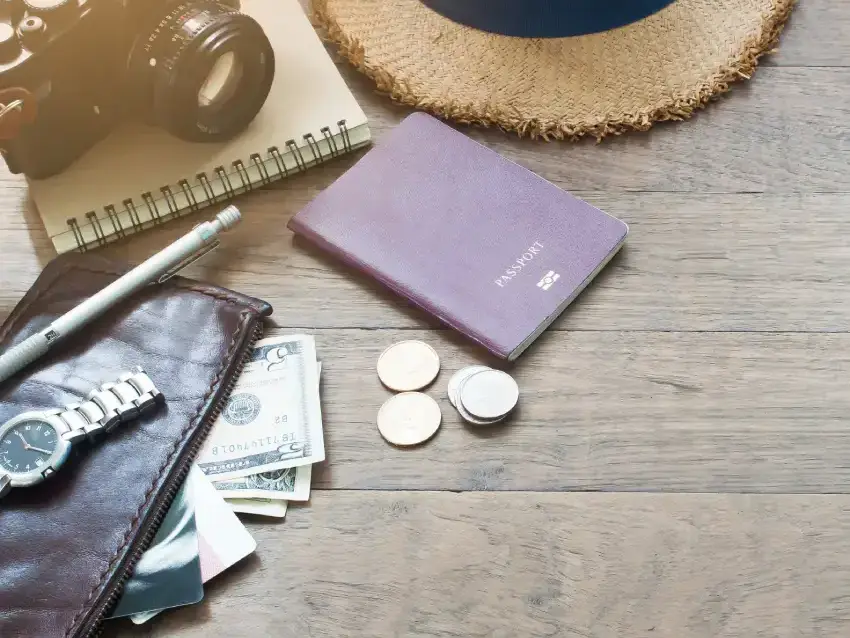 Traveler with passport and travel essentials