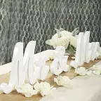White wooden Mr and Mrs letters displayed on a wedding signing table